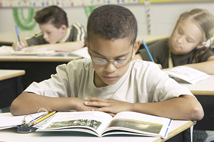 Boy in school reading