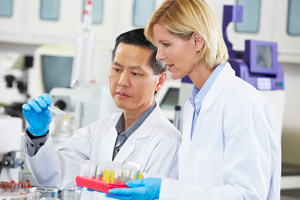 Male And Female Scientists Working In Laboratory